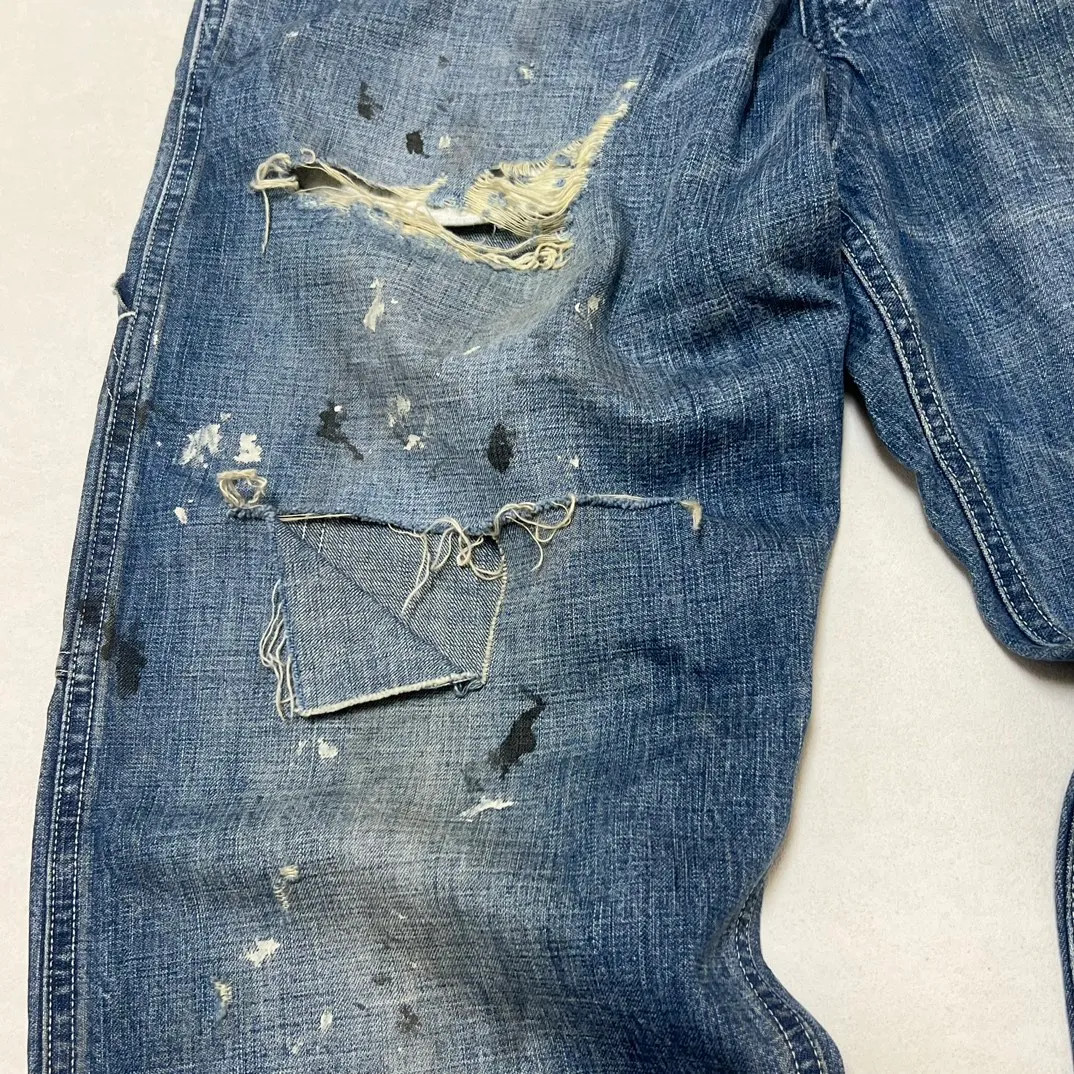 SAINT Mxxxxxx SAINT_DENIM PANTS/PAINTER /BLUE Logging trousers with knife-cut holes and splashed ink. Patch jeans. Blue S-XL. All accessories are molded and customized. Super heavy work. Washed and distressed. Knife-cut holes. Artificial splashed ink graffiti. Authentic version. Loose and stylish.
